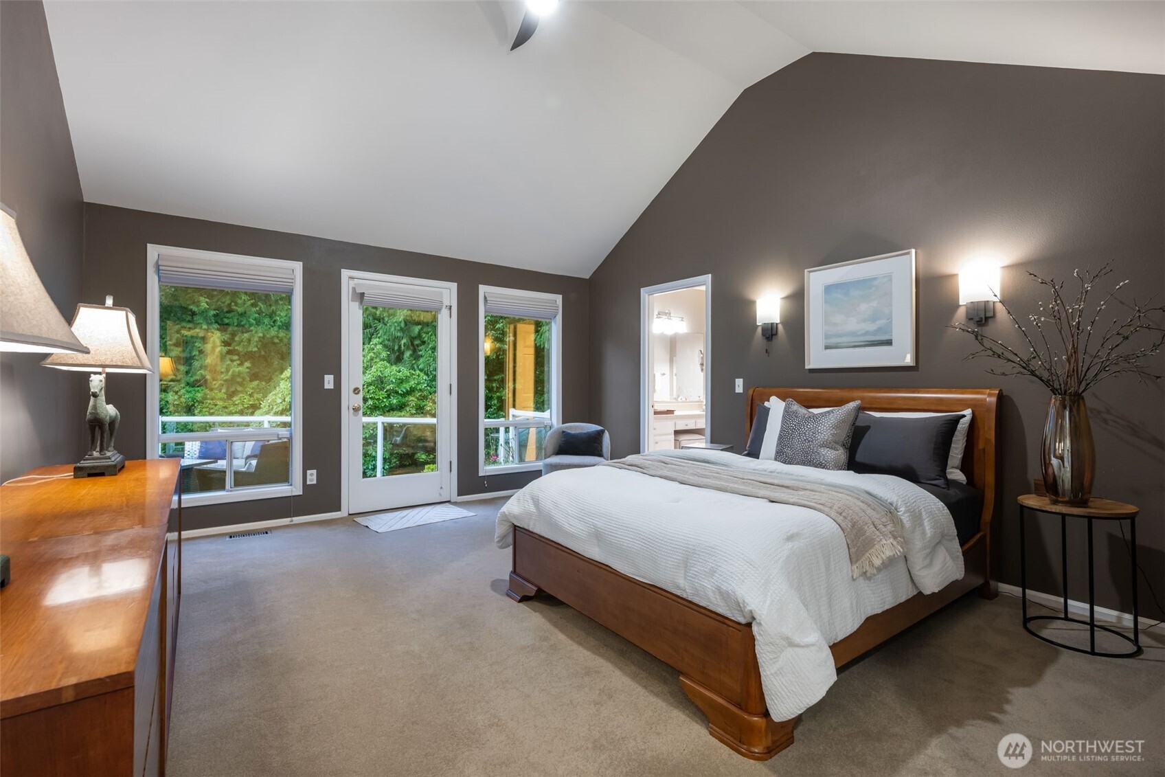 Sunken living room with dual burning wood & gas fireplace, overlooks the expansive backyard.