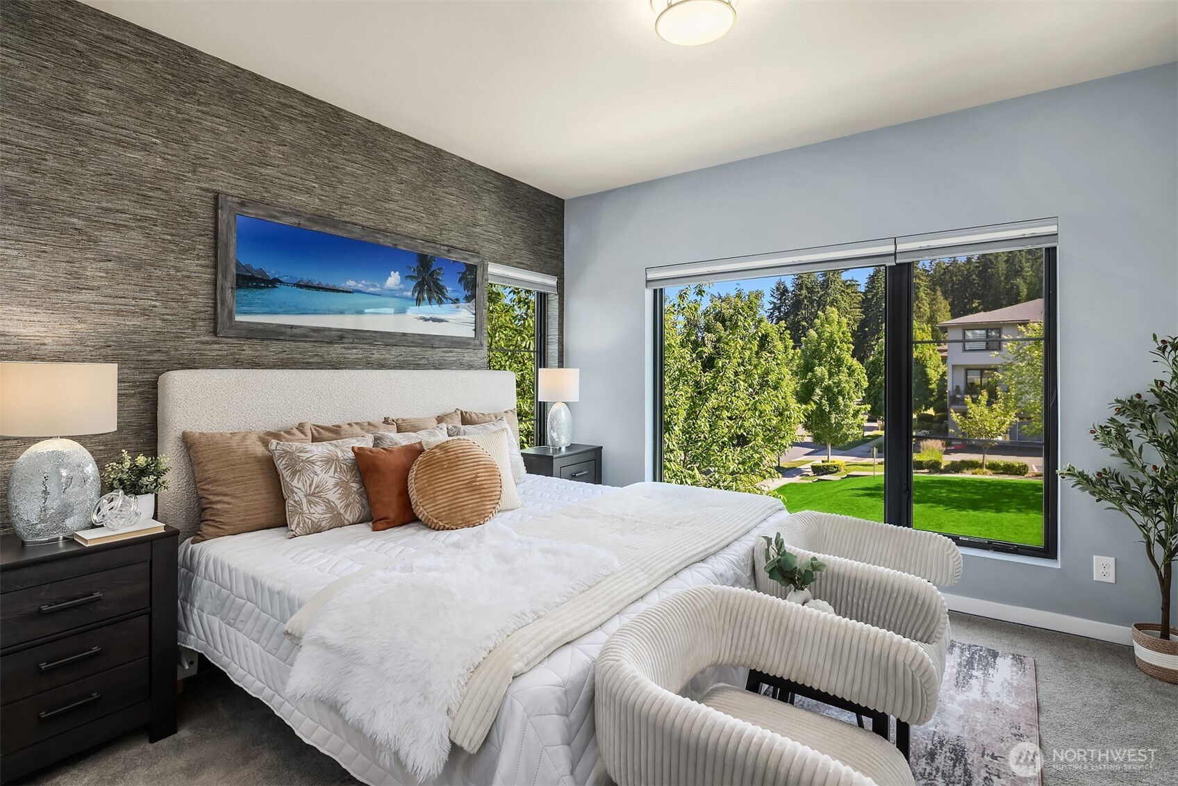 Upper level primary suite with huge picture window overlooking the community space. Owners added top down/bottom up black out blinds in all bedrooms