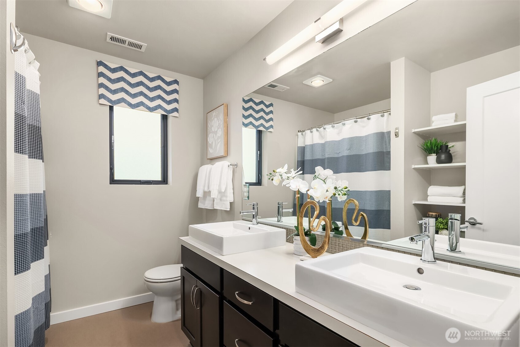 The upper floor bathroom with dual vanities and tub. Not shown is additional storage - so practical and stylish