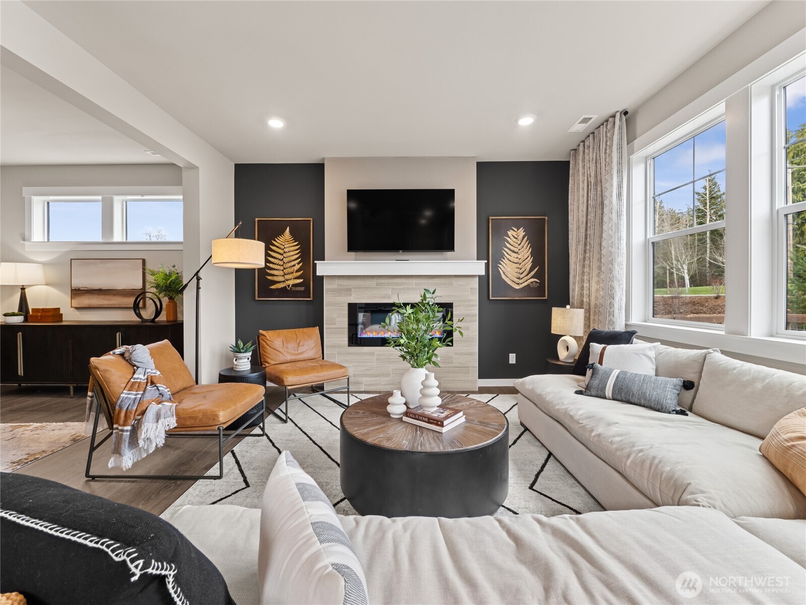Light, bright family room with cozy gas fireplace. Photo is representational. Actual home is under construction and finishes and paint colors may vary. See site agent for details....