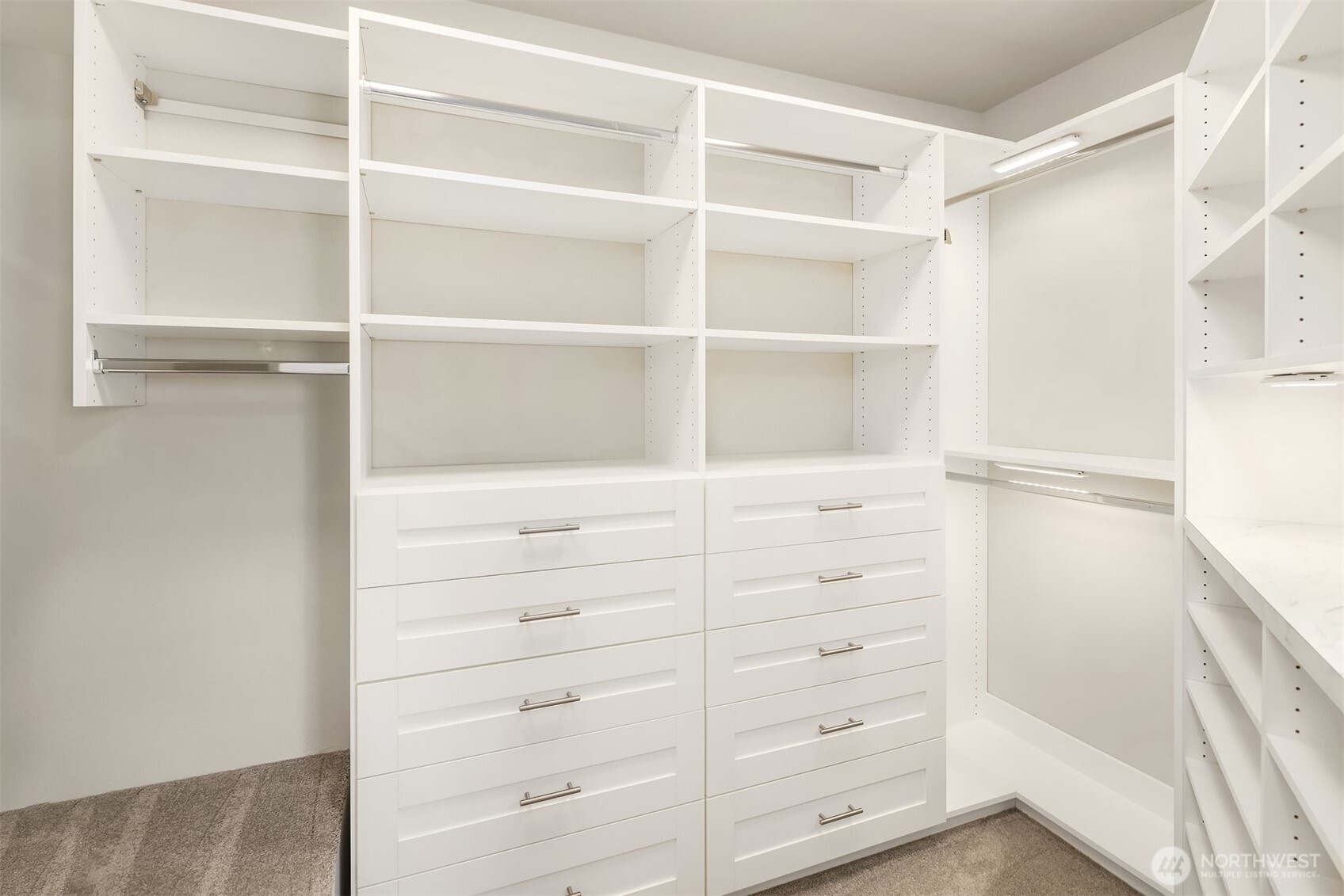 Large, fully kitted out closet for the primary suite giving a place for everything