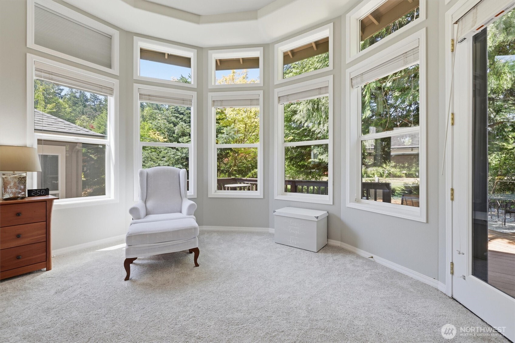 Sitting area in the primary also has an access door to the back deck.