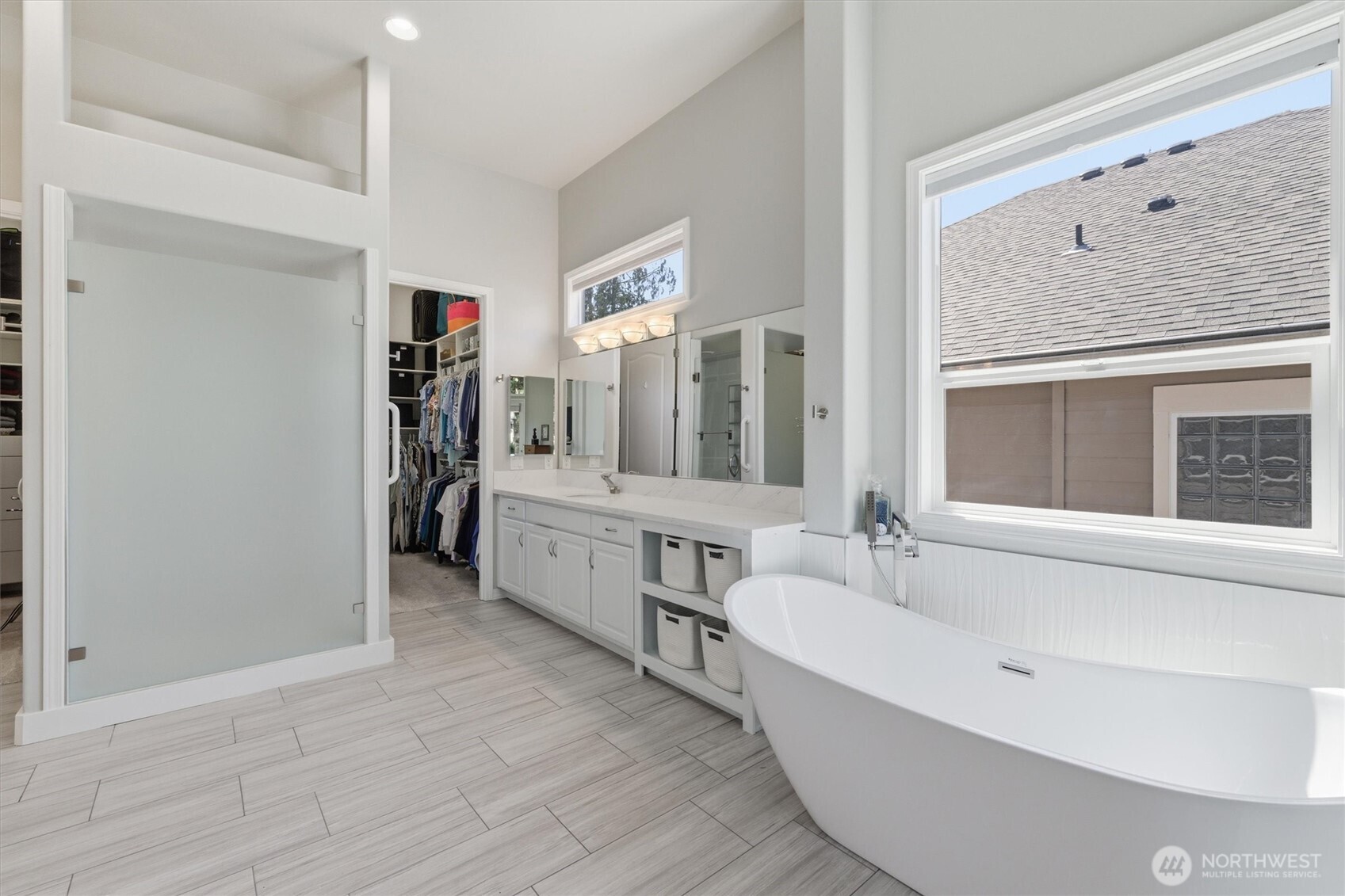 This shows the large shower and one of the two vanities.