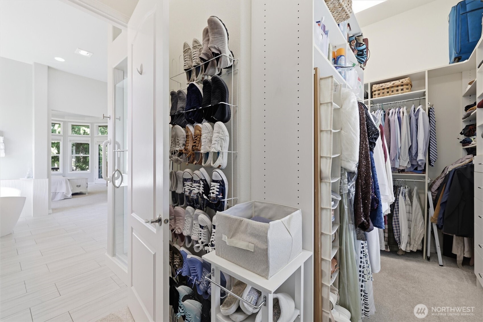 Bathroom has a large walk-through closet with plenty of space and a lot of light.