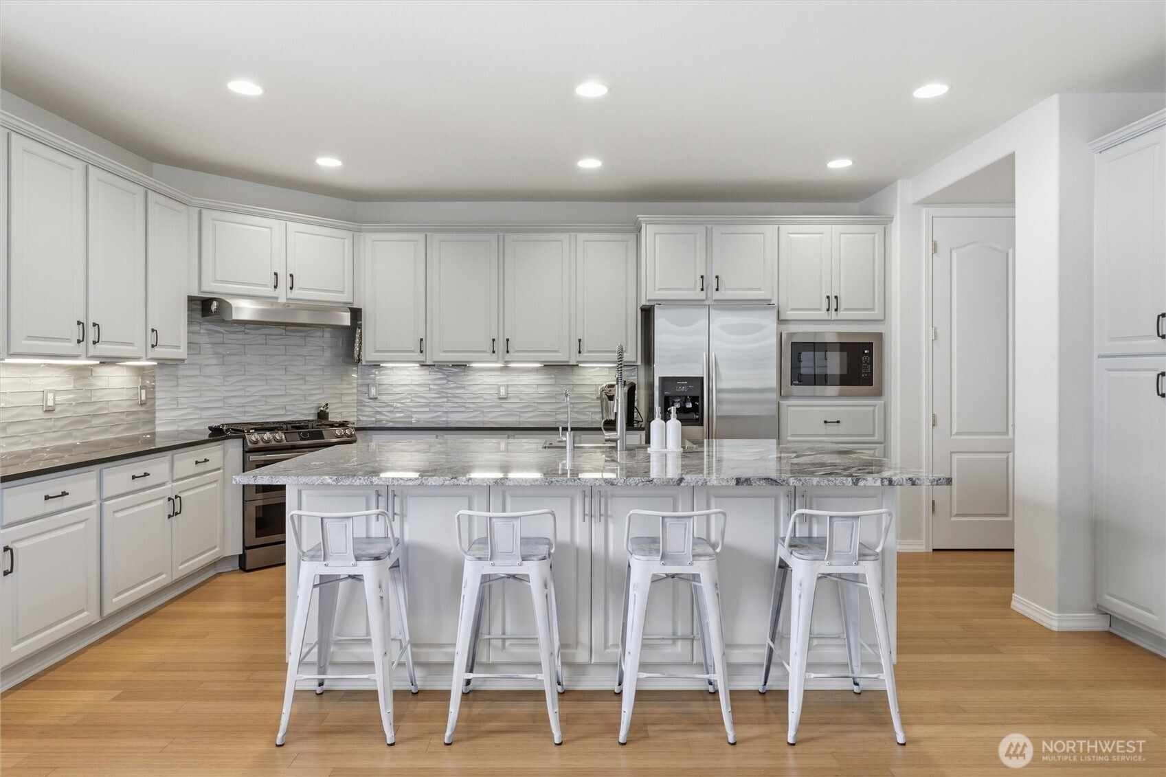 Stunning kitchen remodel with large island and eating space.