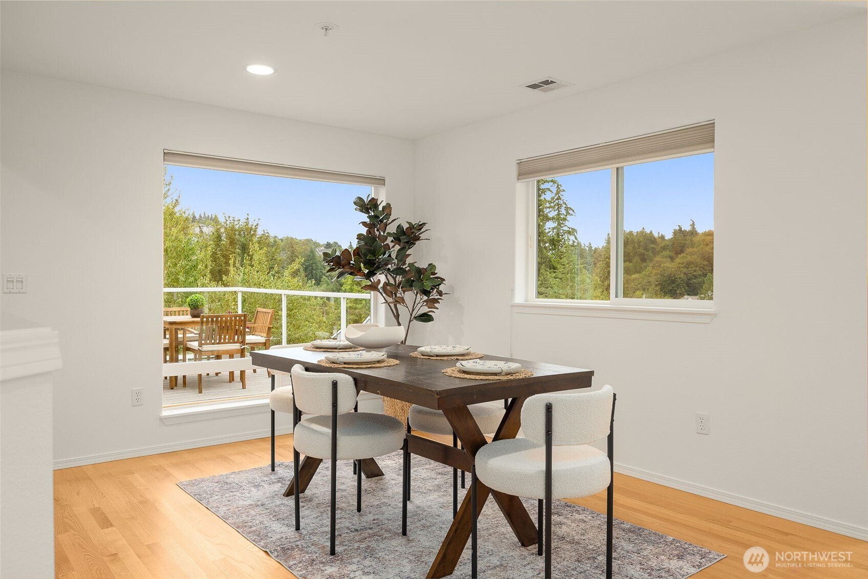 Living room opens to a dining area adjacent to a large deck