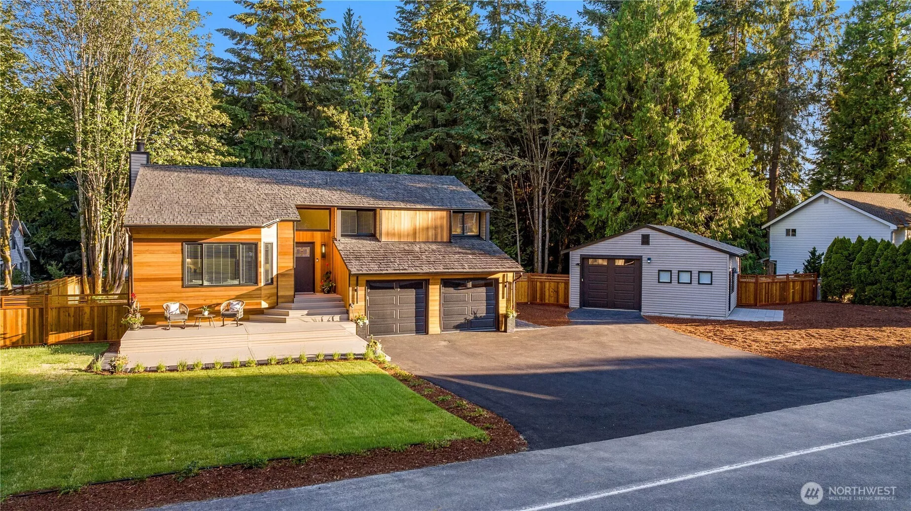 Northwest contemporary style with modern Craftsman influence gives this home a striking first impression, with warm wood siding, strong horizontal lines, dark-framed windows, broad roof planes, clean trim, and a natural setting that feels distinctly Pacific Northwest. The garage doors are new, along with new garage door openers and remotes, and the inside of the garage has been sheet-rocked and finished, and a EV electric car charger has been installed!