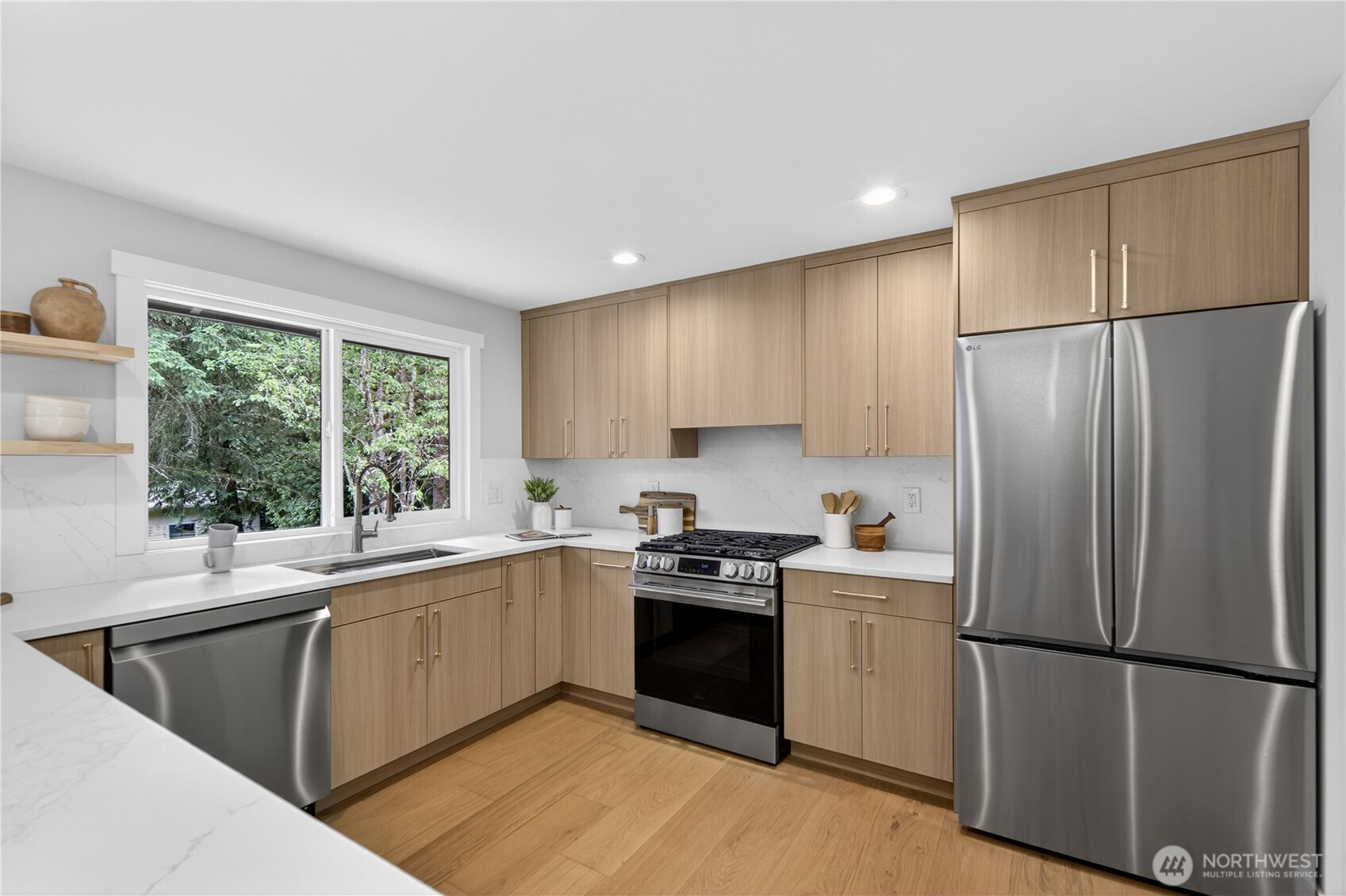 New LG appliances bring polished beauty and everyday ease to the kitchen. Home cooks will appreciate the new 5-burner gas range and oven, offering the responsive heat control people love, paired with a hood that vents outside to help keep the air fresh. A new LG French door refrigerator, complete with water dispenser and ice maker, adds wonderful convenience. With the bottom freezer keeping frozen goods tucked below, fresh foods stay at eye level so there is no need to bend down for everyday items.