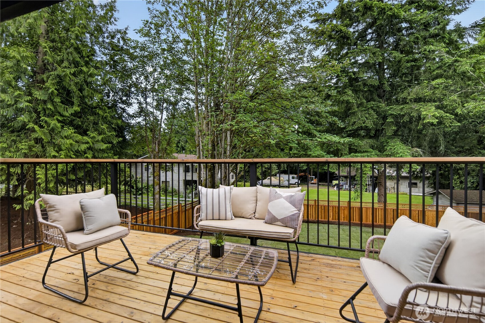 Just off the main living room, the new balcony connects indoor and outdoor living with ease through new sliding glass doors. Matching railings continue the home’s clean modern style, while lovely views across the private back yard and into the treetops create a quiet treehouse feeling surrounded by trees and birdlife. Its easy access from the kitchen and dining area also makes it a wonderful spot for those who love to barbeque. With its sunny southern exposure, it is a beautiful place to watch evening colors settle into the sky in shades of gold, peach, and rose beyond the trees.