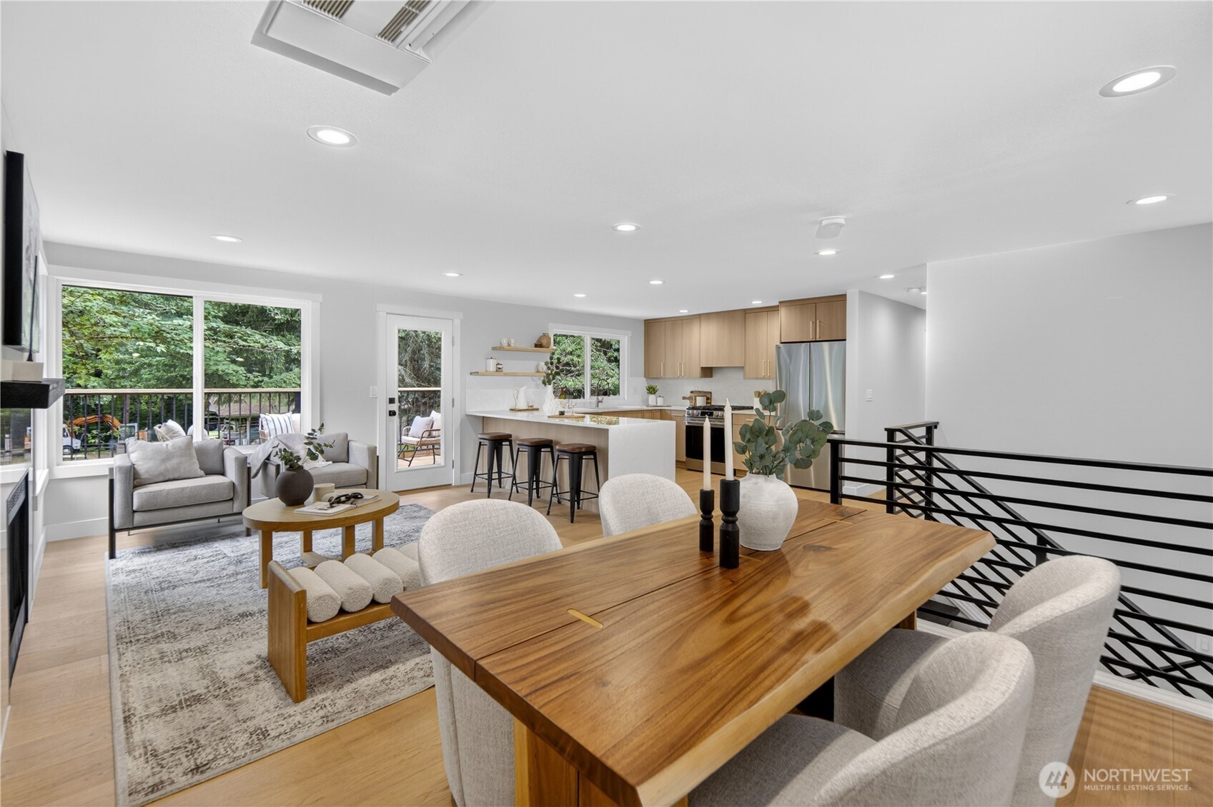 The upper floor opens beautifully for everyday togetherness, with the living, dining, and kitchen areas flowing easily from one space to the next. Large south-facing windows bring in natural light, giving the main living areas a bright, comfortable feel throughout the day.