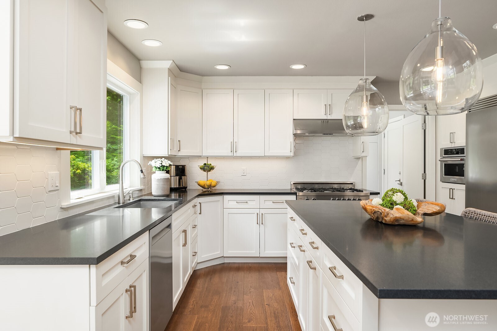 This angle of the kitchen highlights the generous counter space, elegant pendant lighting over the island, and premium finishes throughout, making it as beautiful as it is practical for everyday cooking and entertaining.