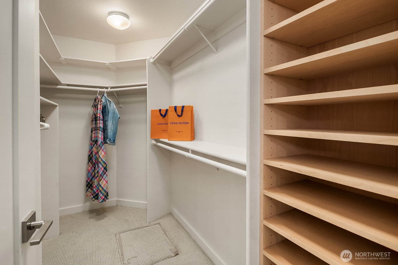 The primary suite includes a spacious walk-in closet with built-in shelving and hanging space, offering exceptional organization and storage for everyday convenience.