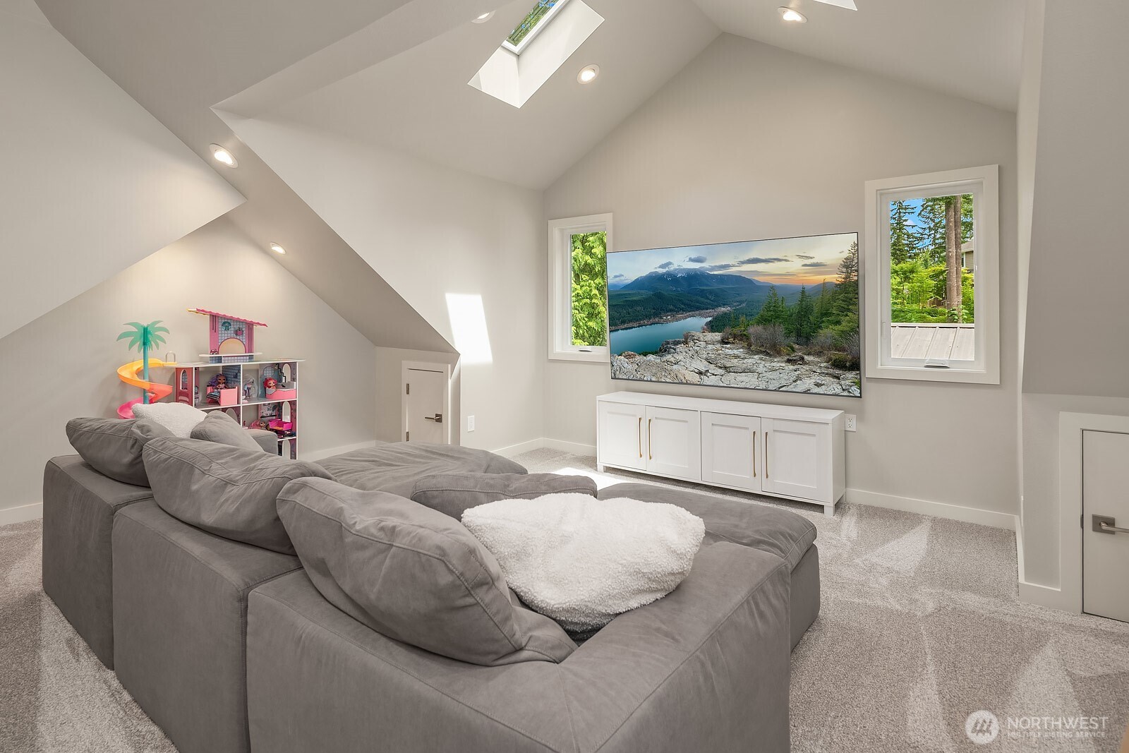 The newly finished bonus room offers a versatile and light-filled retreat with vaulted ceilings, new windows, and plenty of space for play, lounging, or a kids' hangout area tucked away from the main living spaces.