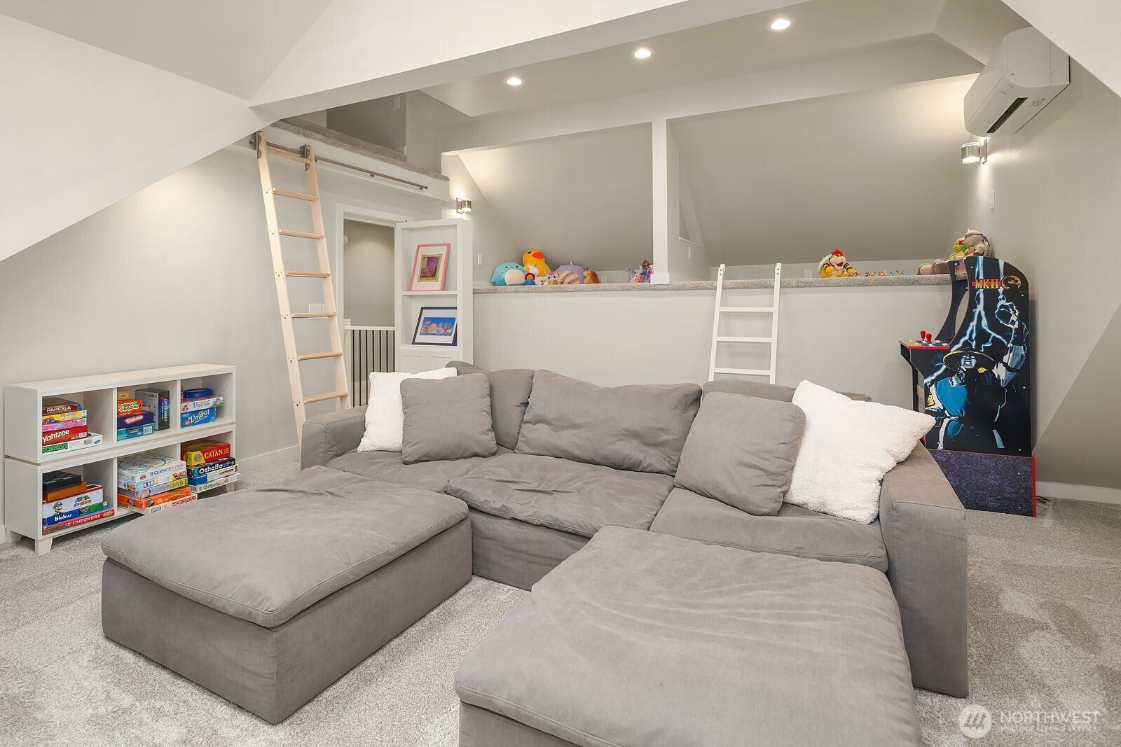 A second angle of the bonus room reveals the fun play lofts and abundant built-in storage, making this hidden space behind the bookcase door a truly one-of-a-kind feature of the home.
