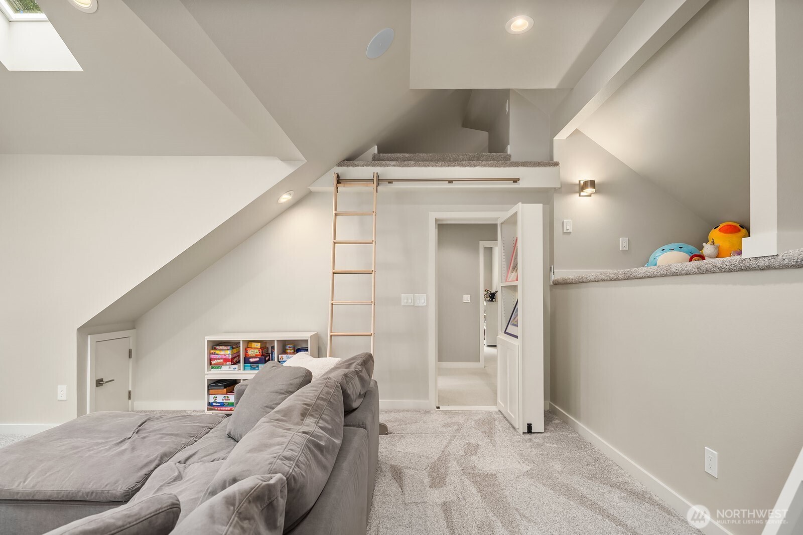 The bonus room's play loft area features vaulted ceilings, built-in storage, and a tucked-away upper level, offering kids an imaginative and functional space to call their own.