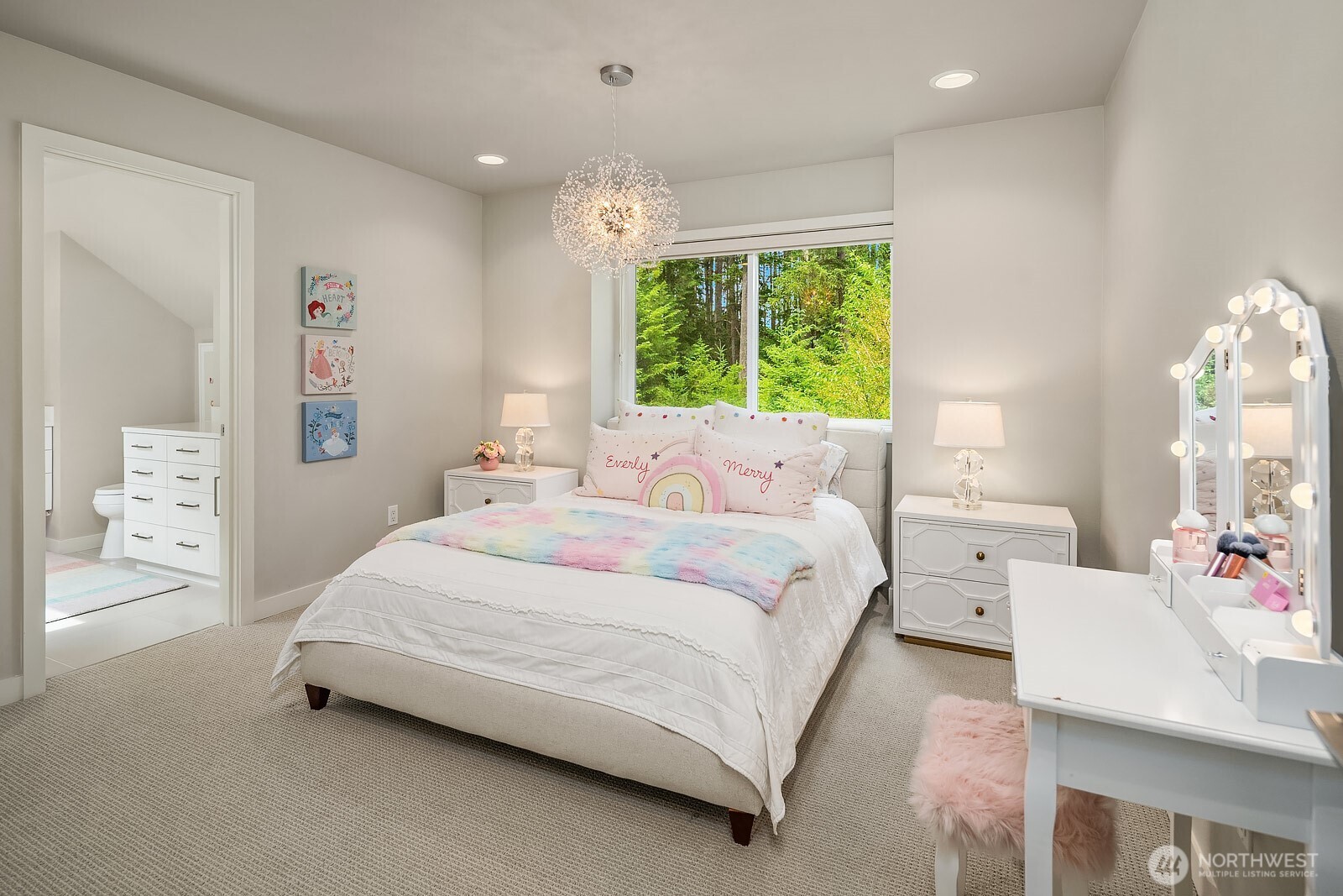 This light and airy upstairs bedroom charms with soft neutral tones, a decorative pendant light, and large windows, offering a bright and inviting space with a touch of whimsy.