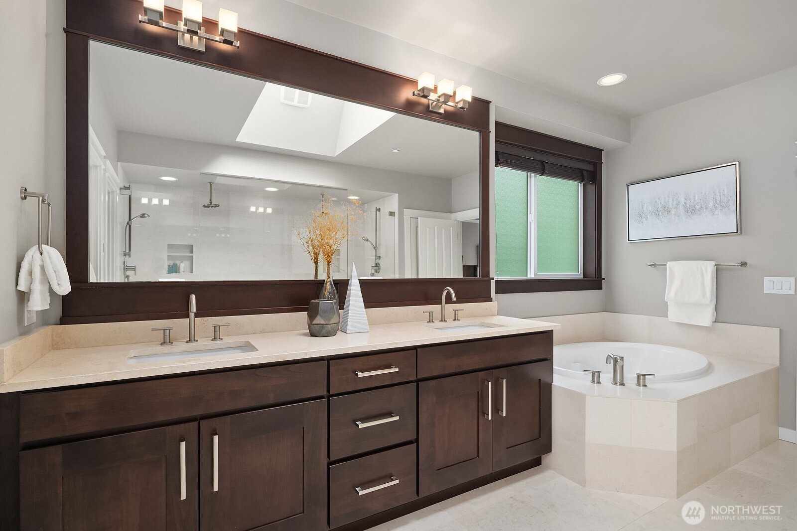 The luxurious primary ensuite impresses with an oversized dual vanity, soaking tub, and premium finishes that create a spa-like atmosphere. This stunning 5-piece bath also features dual showers, delivering the ultimate in comfort and indulgence.