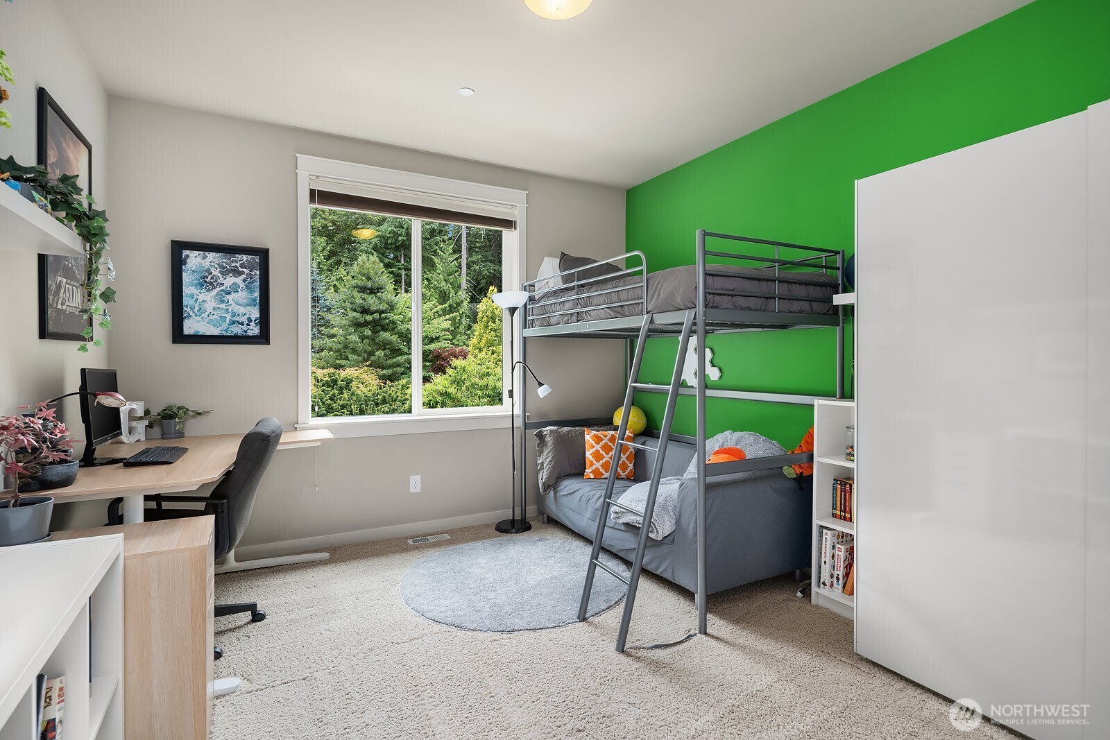Another versatile upper level bedroom offers a bright and cheerful atmosphere with a large window framing lush greenery, perfect for a child's room, guest space, or home office. The flexible layout and ample natural light make this a fun and functional space for any need.