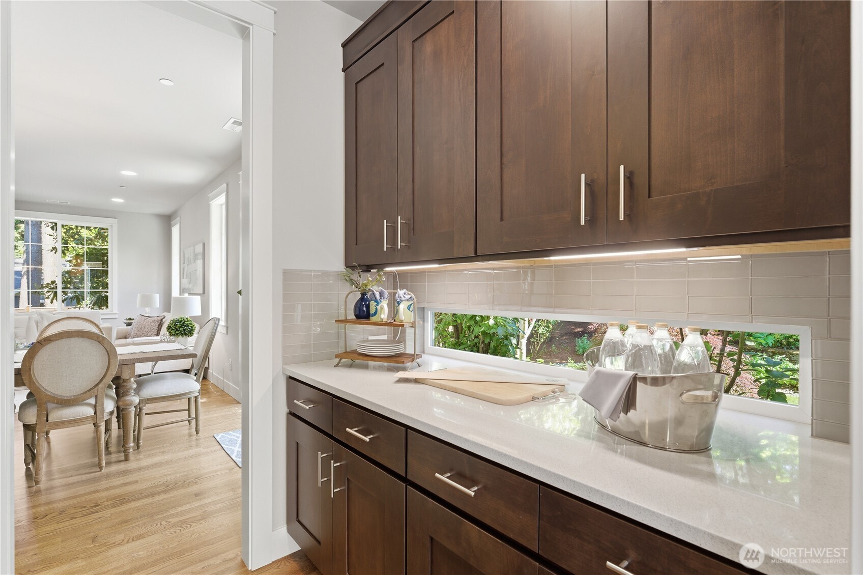 A generous butler’s pantry with elegant cabinetry and a garden-view window. Just to the left (not shown) is the large walk-in pantry, with the formal dining area visible beyond
