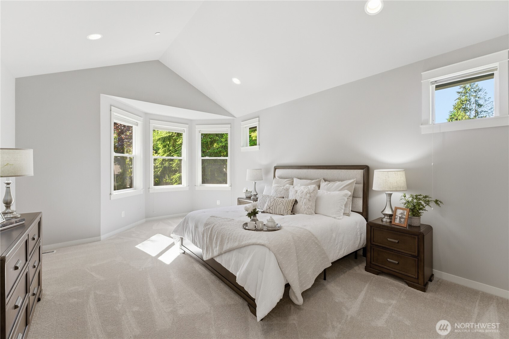 As you arrive on the second floor, double doors frame the large primary bedroom with vaulted ceilings. Natural light pours in from the bay windows and additional, north facing windows. Brand new carpet throughout the entire second floor