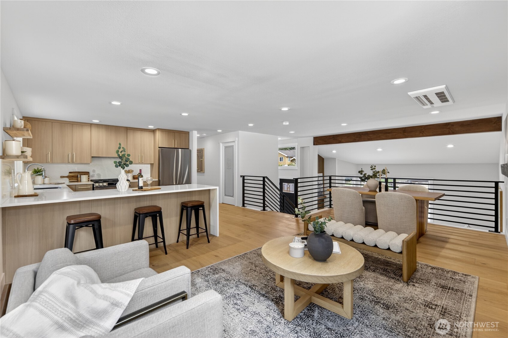 New recessed lighting with warm natural-light bulbs casts an even glow across the whole floor. Beautiful wide floor boards run throughout the top floor, matching the kitchen cupboards, and continue the light uplifting coloring, and are so easy to keep clean and lovely.