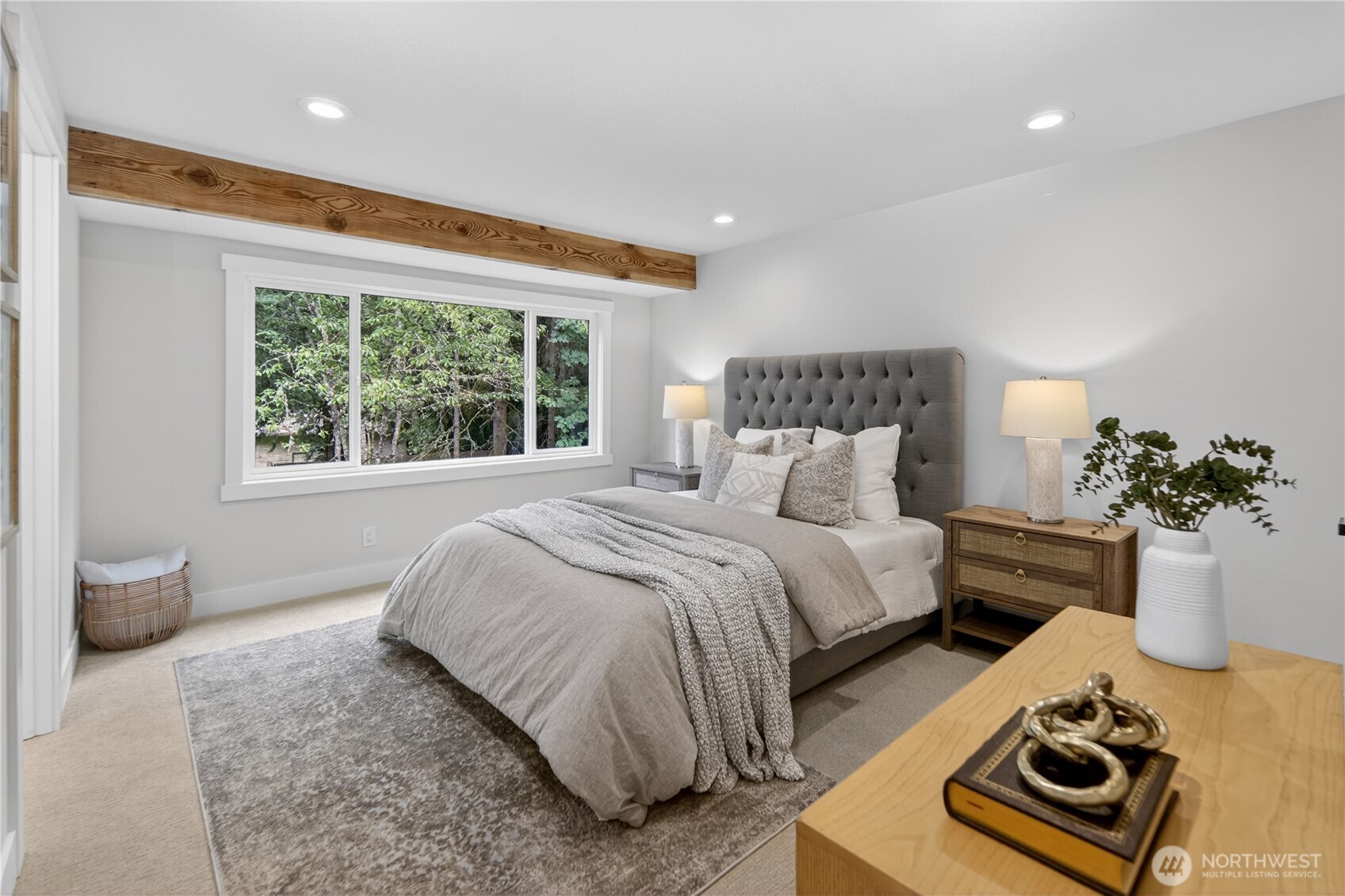 A large south-facing window looks out toward the back yard and surrounding trees, bringing in natural light by day and a soft evening glow as the sun begins to set. With room for a king-size bed, large sets of drawers, and a spacious walk-in closet, the primary bedroom offers the comfort, storage, and easy livability a true retreat should have.