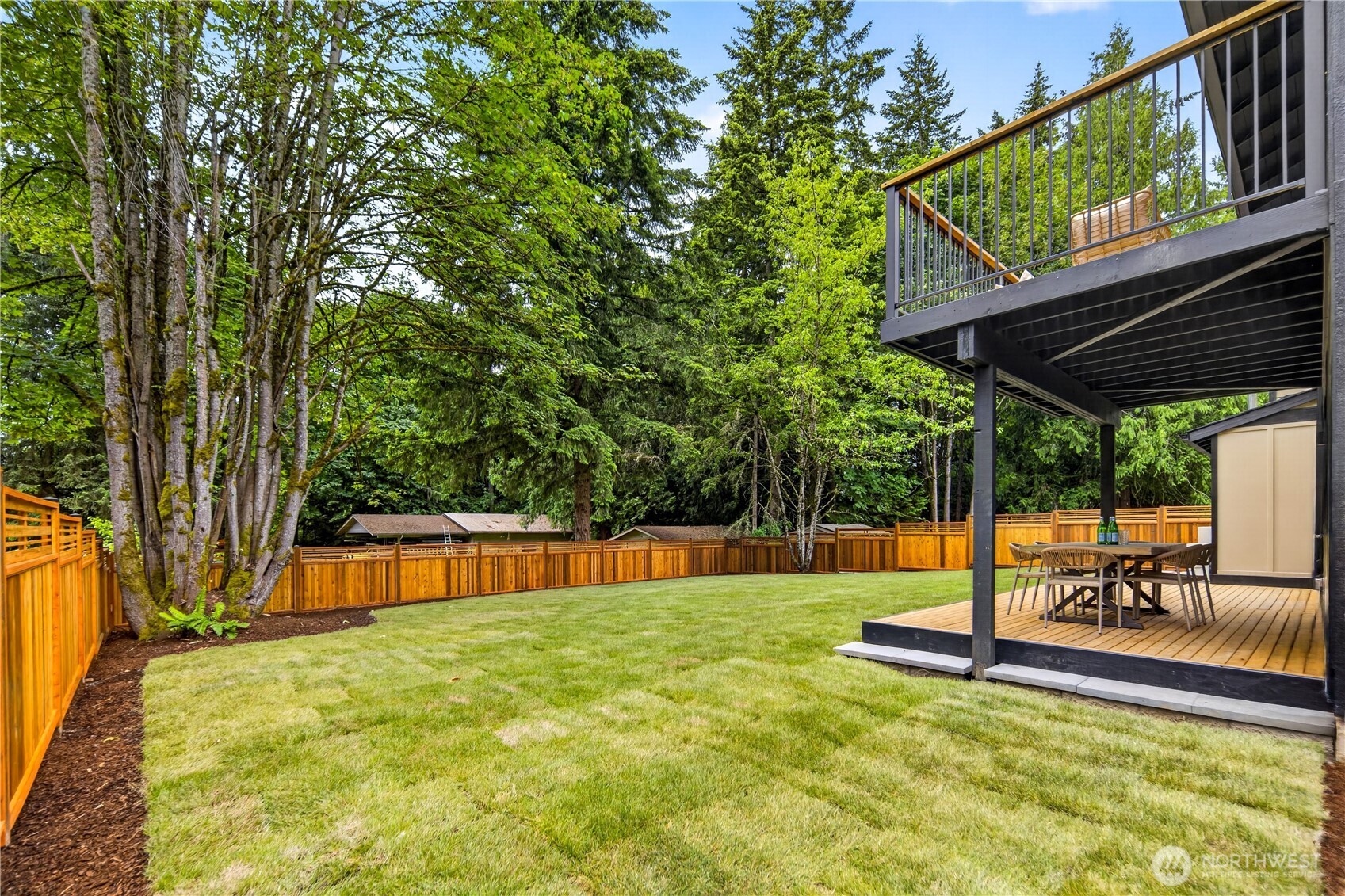 Just outside the lower level rec room, the new covered deck creates a wonderful outdoor extension of the living space. With room for dining, barbeques, and summer gatherings, it opens to the level fenced lawn and creates an easy flow between the kitchenette, rec room, and outdoors. Careful attention was given to the overhead trim, painted to echo the home’s interior millwork and keep the design feeling connected. Mature trees frame the setting with privacy, and the sunny southern exposure makes this a lovely place to relax as evening colors settle through the trees.