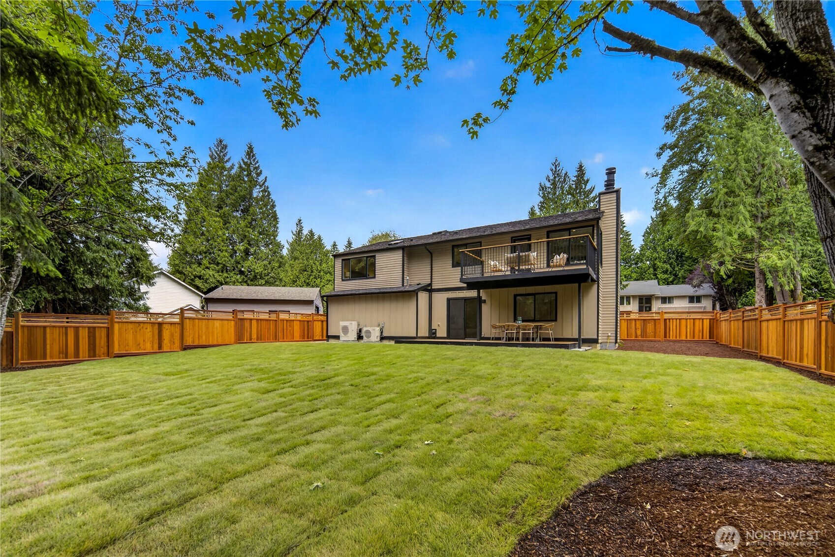 The fully fenced back yard offers a beautiful, usable outdoor setting with a flat new lawn for play, pets, and relaxing in the sun. A new fence with decorative lattice adds privacy and charm, while garden space along the edges leaves room for flowers, shrubs, or seasonal plantings. Lovely mature shade trees frame the yard, giving the space a peaceful, sheltered feel.