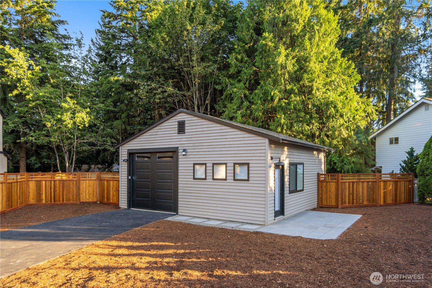 The detached 680 sq ft garage has been finished with the same care as the home, with striking black trim, handsome garage door panel windows, and plentiful windows that bring natural light into the space. Use it as a shop, studio, or quiet home office with the easiest commute imaginable, a peaceful separate workspace just steps from the house when it is time for lunch.