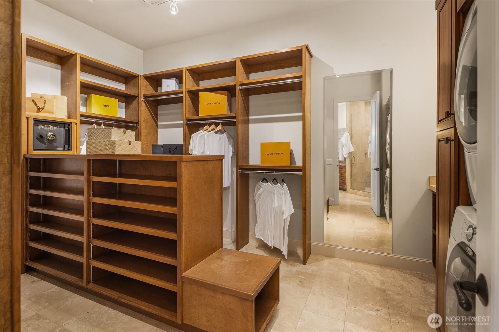 Primary closet loaded with storage and laundry.