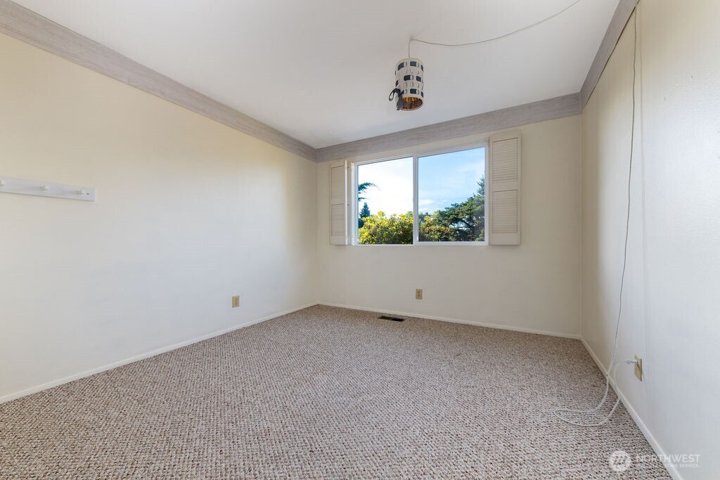Large primary suite enjoys a view of the tranquil private backyard lined by mature statuesque trees and the convenience of a 3/4 bath ensuite.