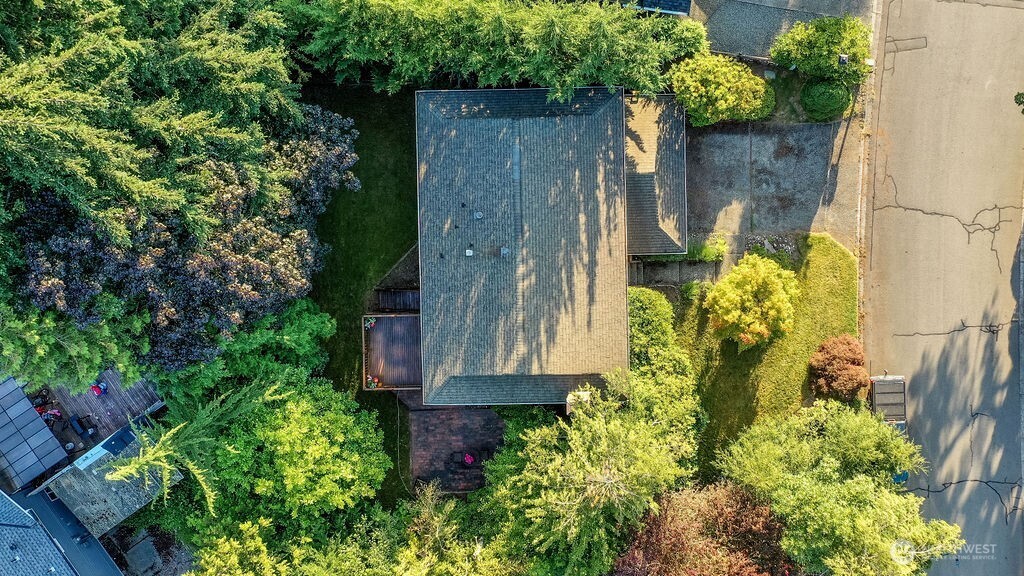 Surrounded by mature evergreen landscaping, cherry trees, and grape vines, the home's highlight is a beautiful, private backyard complete with a cedar deck, brick patio and line of statuesque trees providing total privacy.