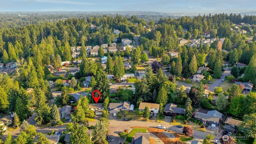 Surrounded by mature evergreen landscaping, cherry trees, and grape vines, the home's highlight is a beautiful, private backyard complete with a cedar deck, brick patio and line of statuesque trees providing total privacy.