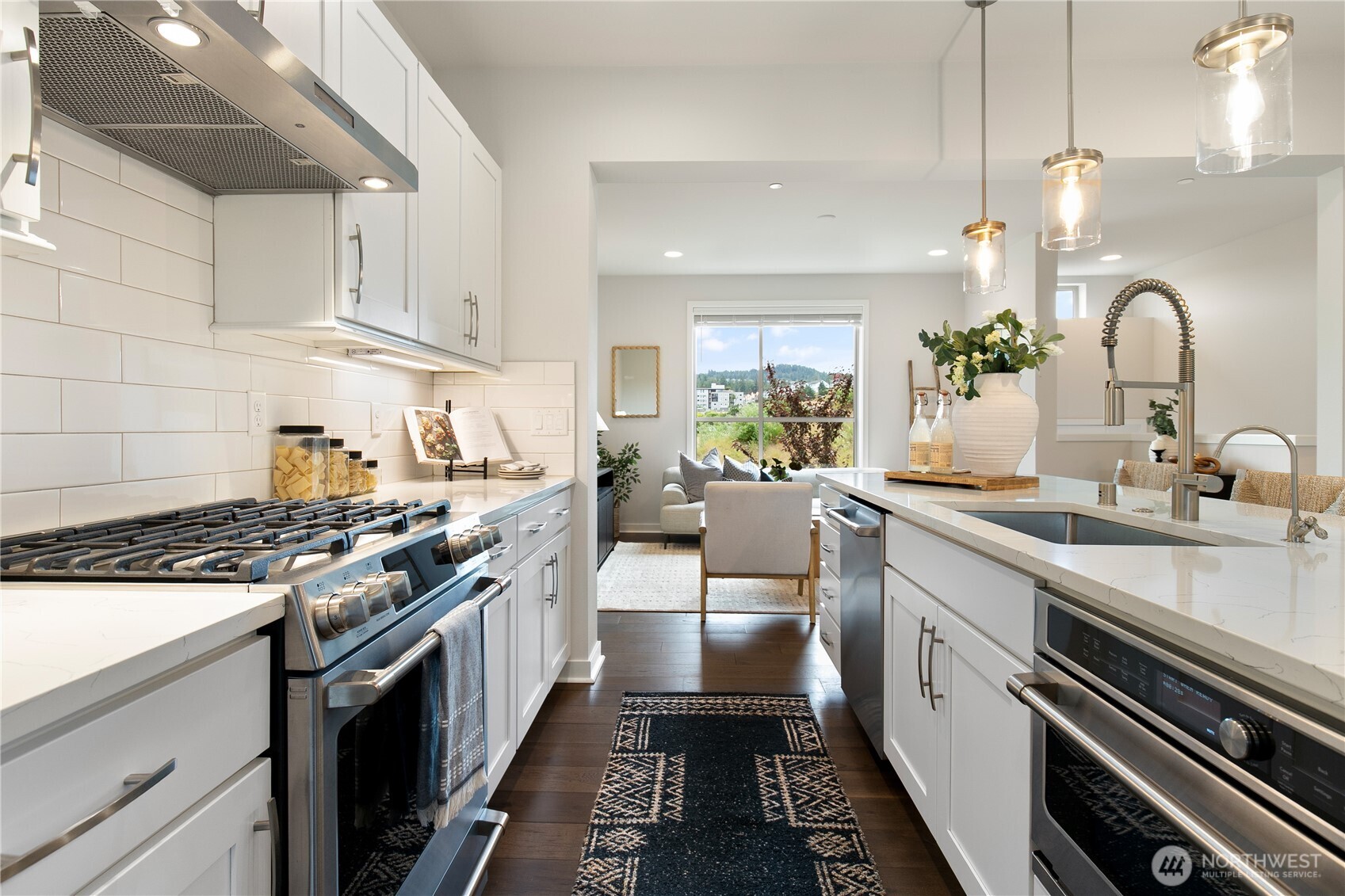 Gourmet kitchen with quartz counters and stainless appliances.