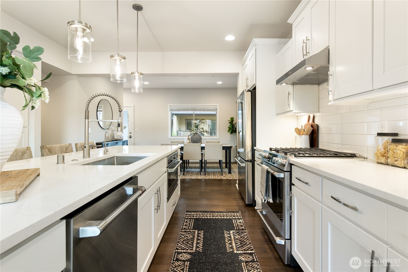 Gourmet kitchen with quartz counters and stainless appliances.