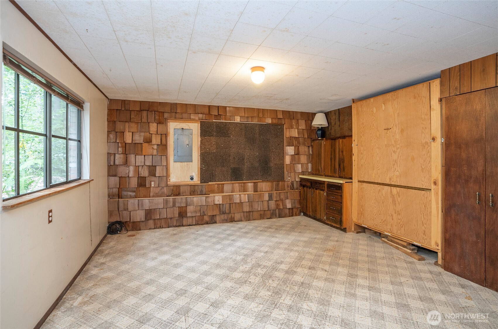 Different view of the lower-level recreation room with added living flexibility.  Murphy bed is an added feature.