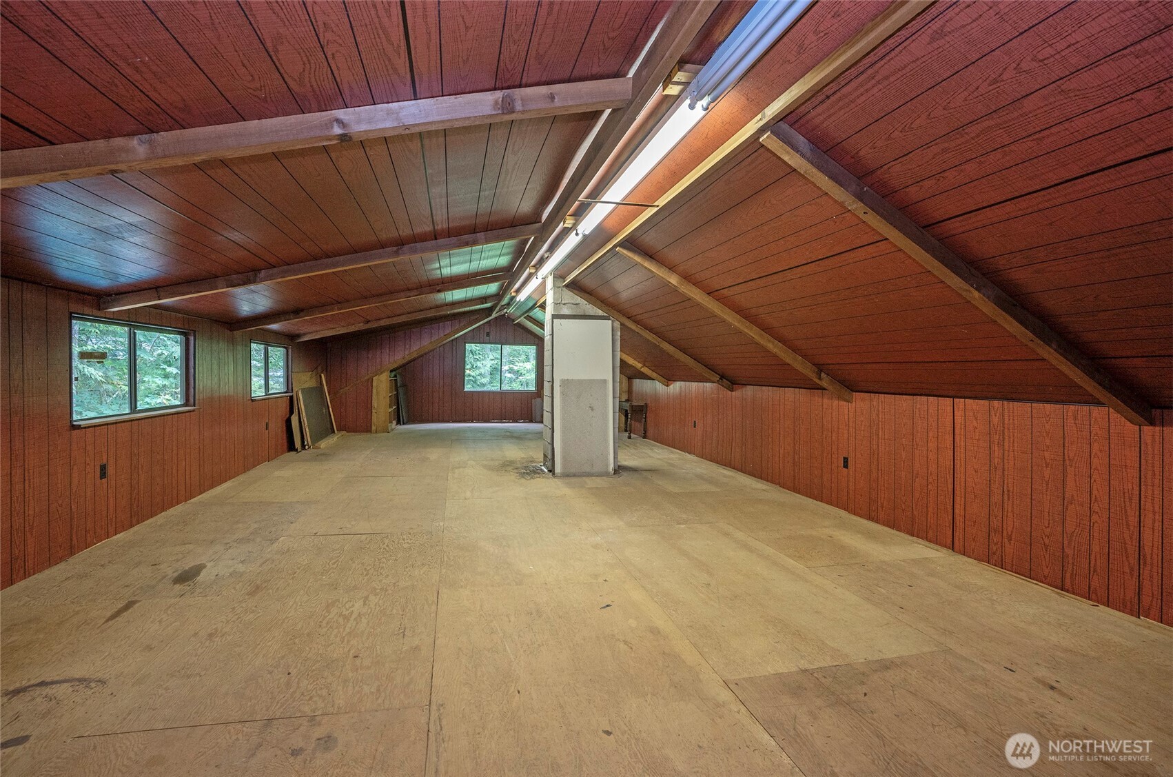 Huge partially finished attic expands the possibilities even further, complete with lighting and subflooring—perfect for organized storage today or future finishing potential.