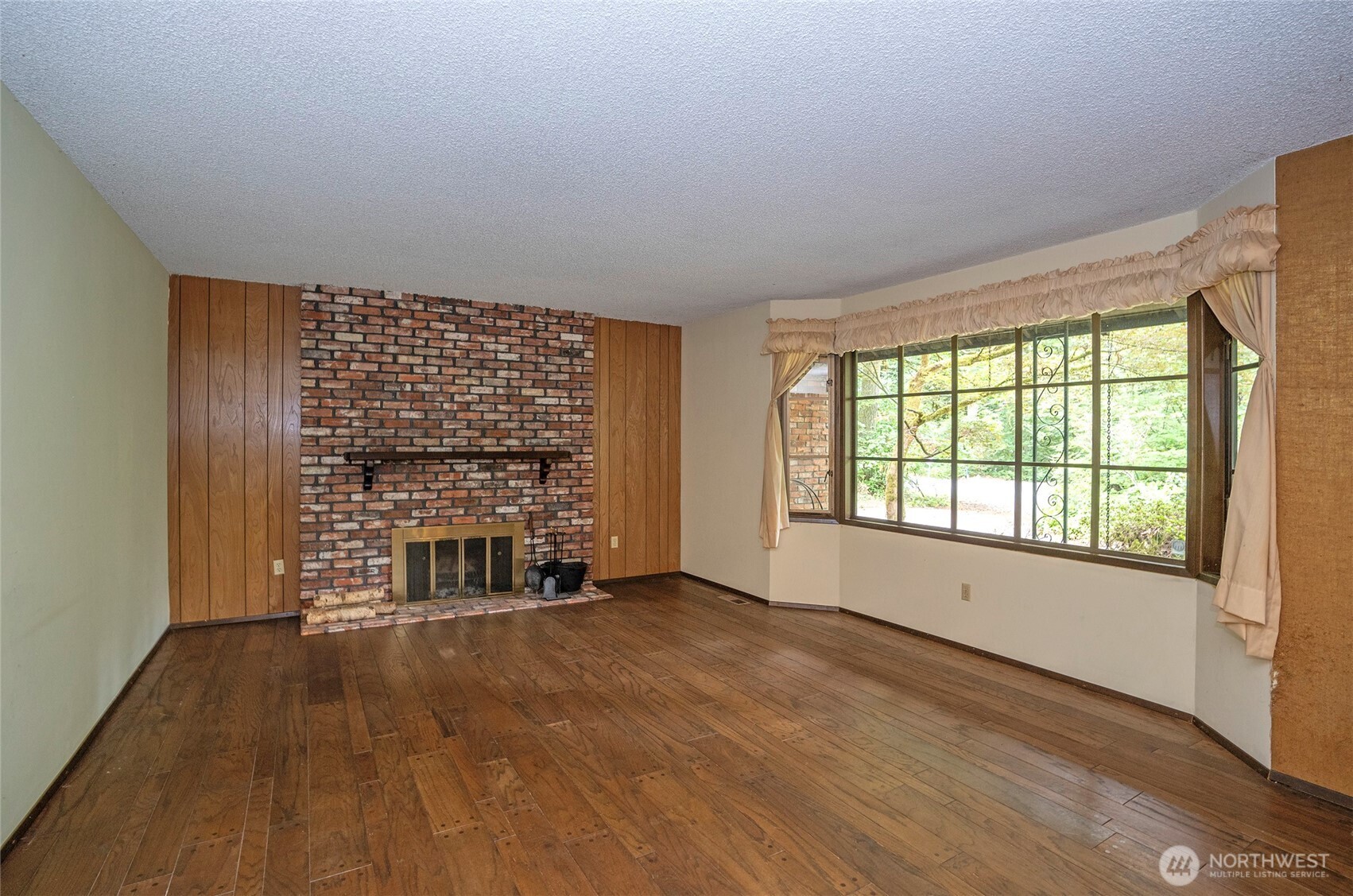 Living area features a brick fireplace, stubbed for gas conversion for added convenience and efficiency.