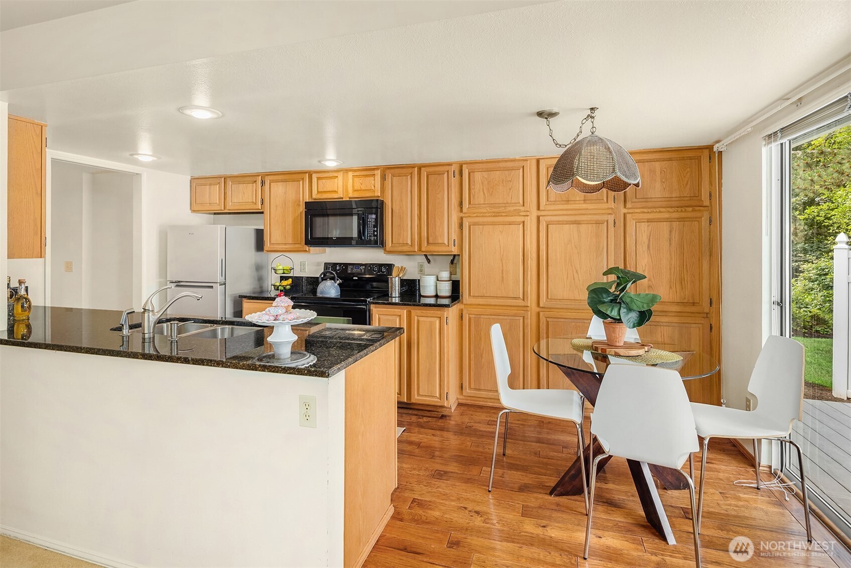 Kitchen with eating space and access to deck and the lovely landscape.
