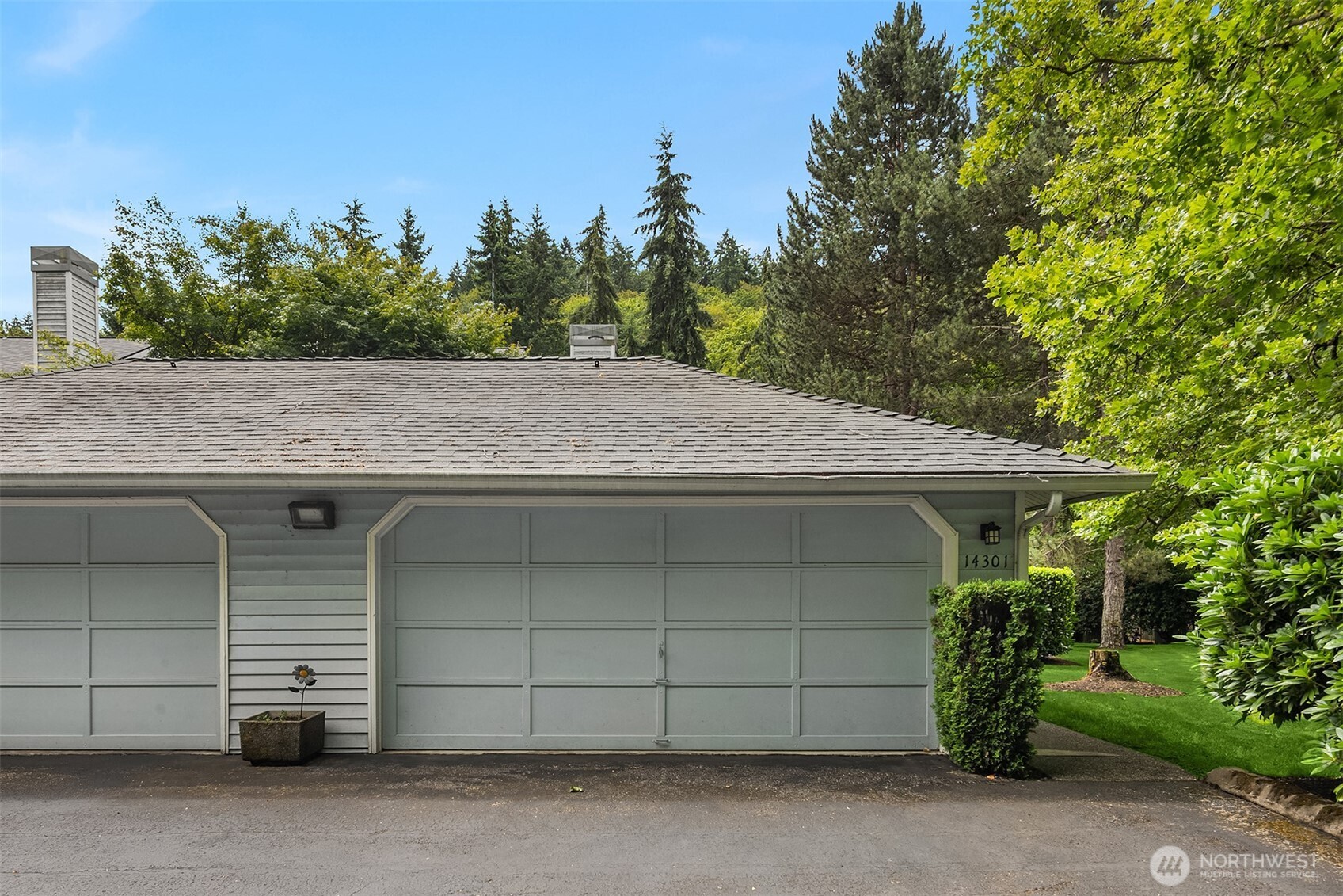 Two-car garage has extra storage and workbench for handy person.  Enter condo from the walkway on the right of garage.