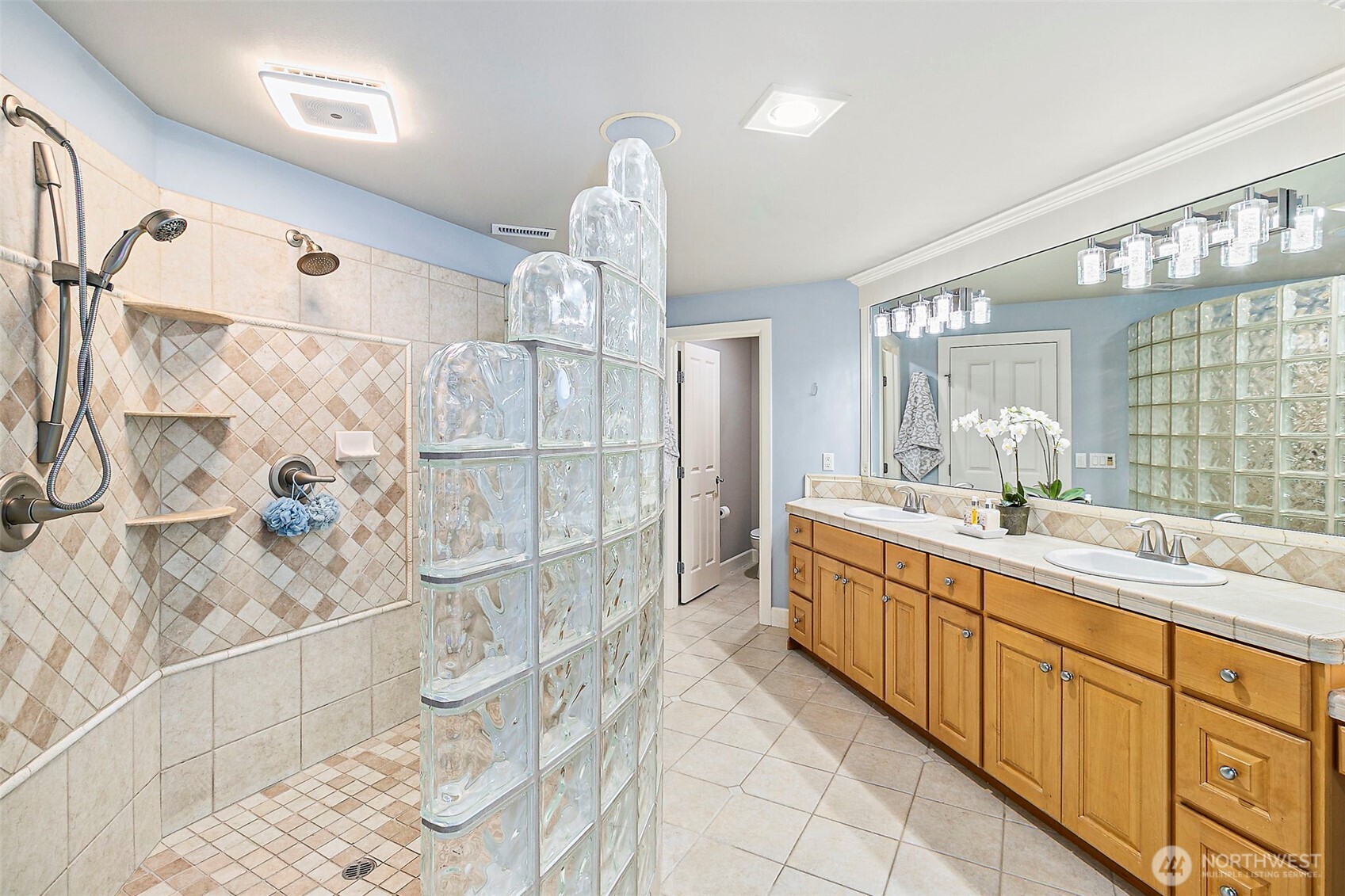 Huge walk-in glass block shower.