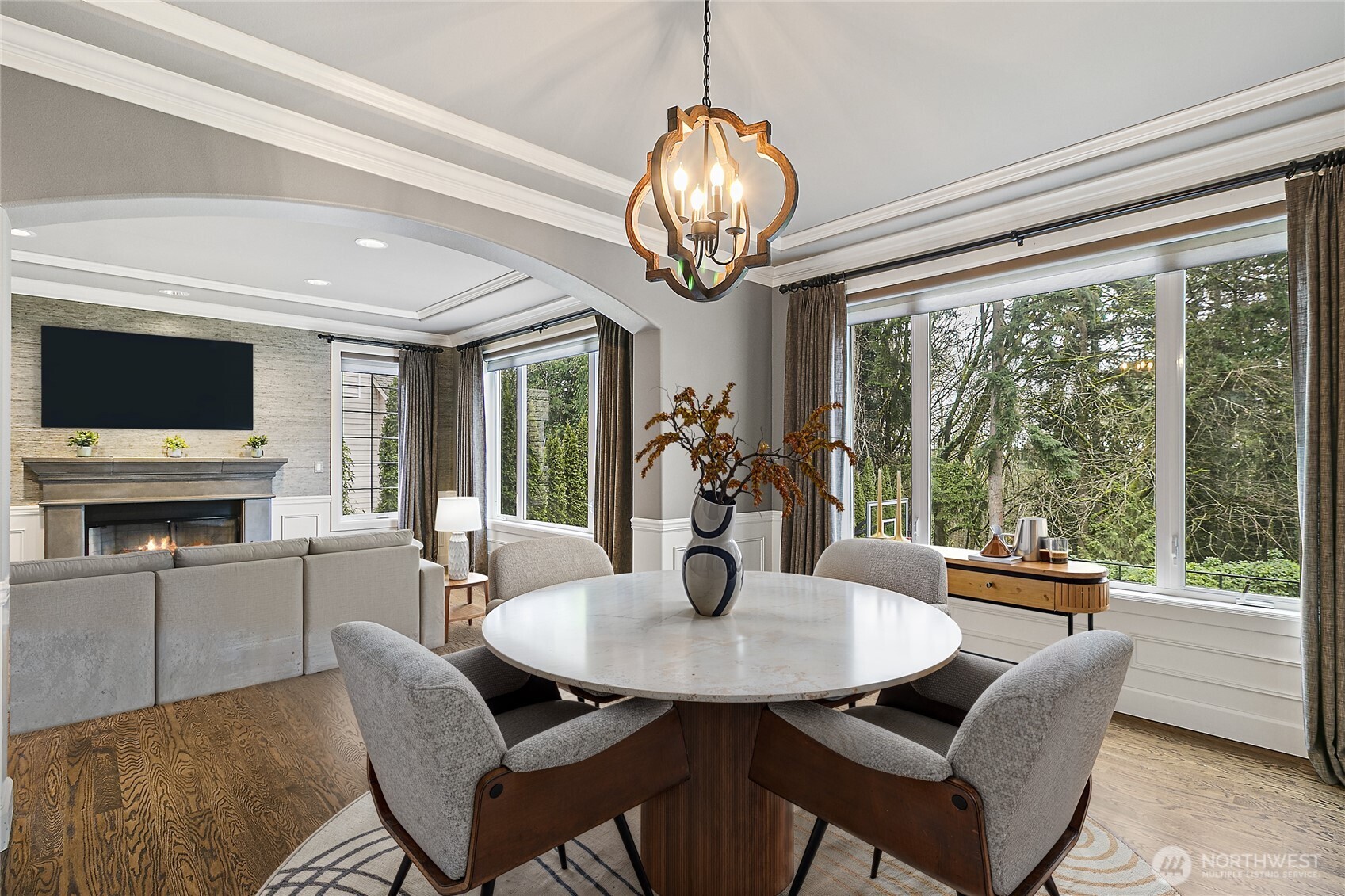 Formal Living Room is bathed in natural light with many tall windows.