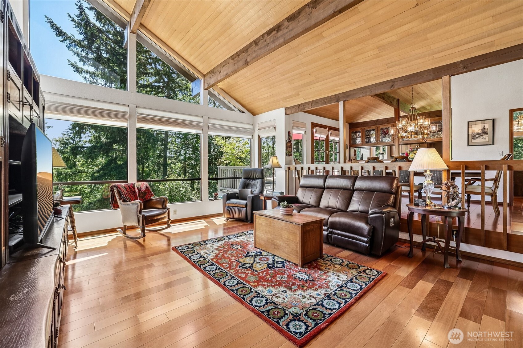Open great room with walls of glass & forest views