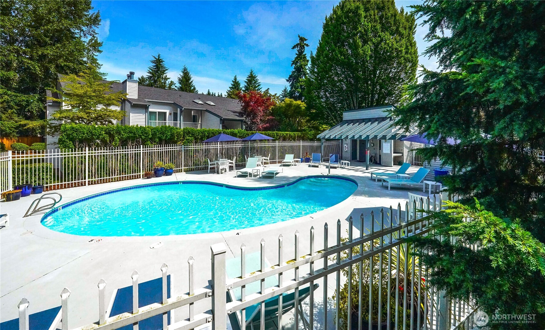 Residents enjoy resort-inspired amenities including a swimming pool, newly resurfaced sport court for pickleball and basketball, and landscaped grounds.