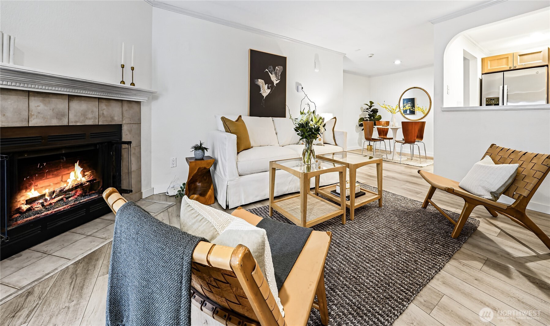 Wide-plank luxury vinyl flooring flows seamlessly throughout the home, complemented by bright new paint, crown moldings, and a fireplace that anchors the space with warmth and character.