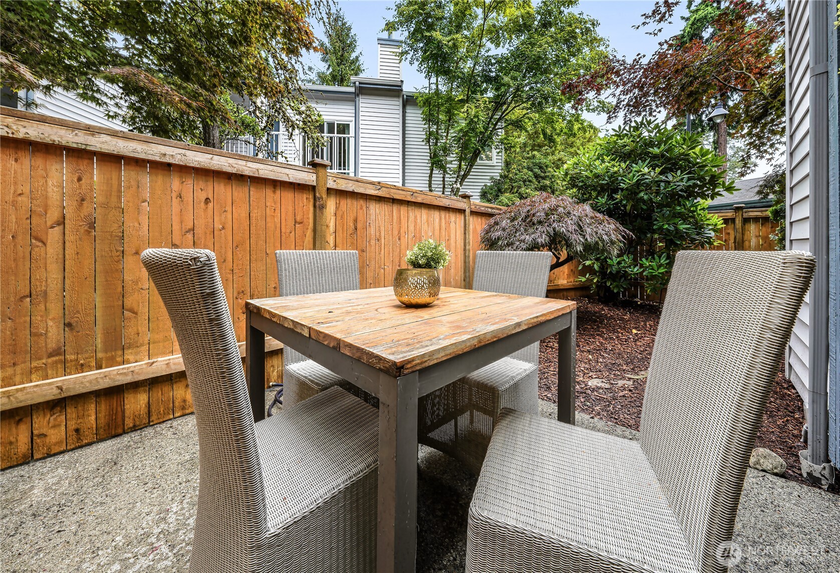 A fully fenced patio and private yard extend the living space outdoors, creating an inviting and private setting for alfresco dining or secure space for pets.