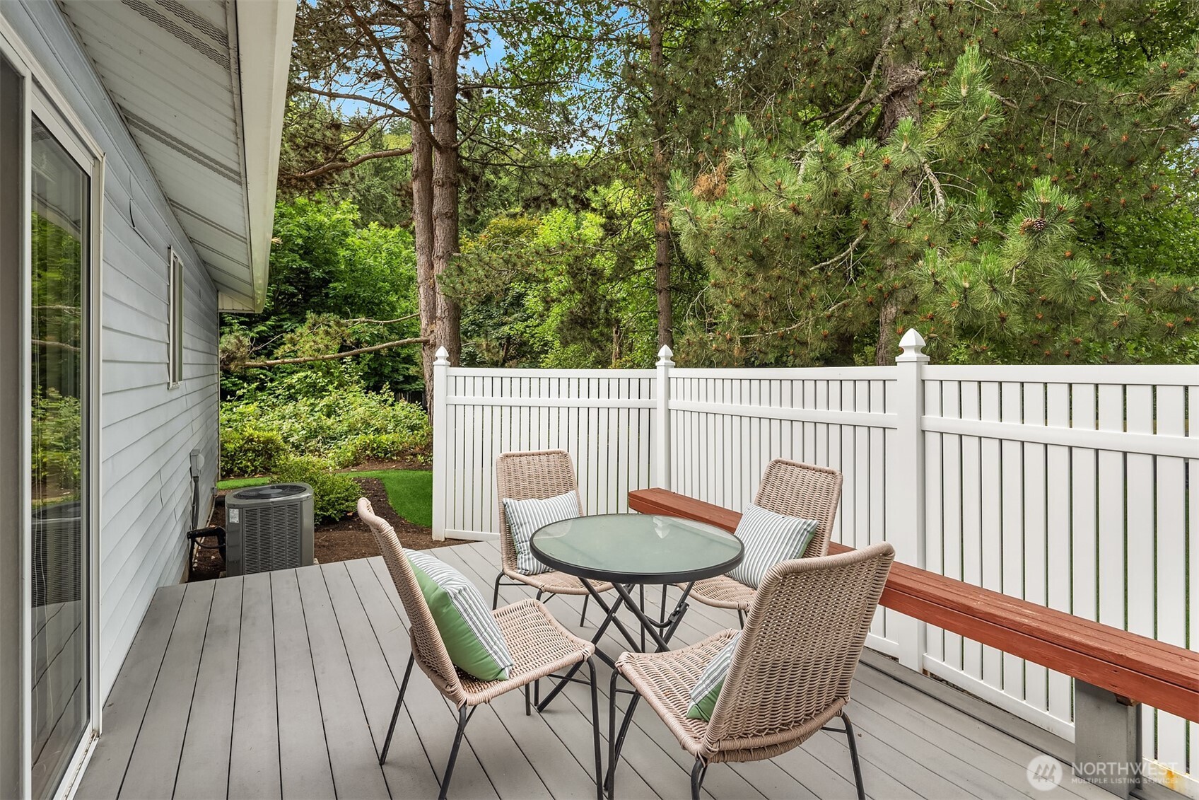 Generous deck overlooks park-like setting