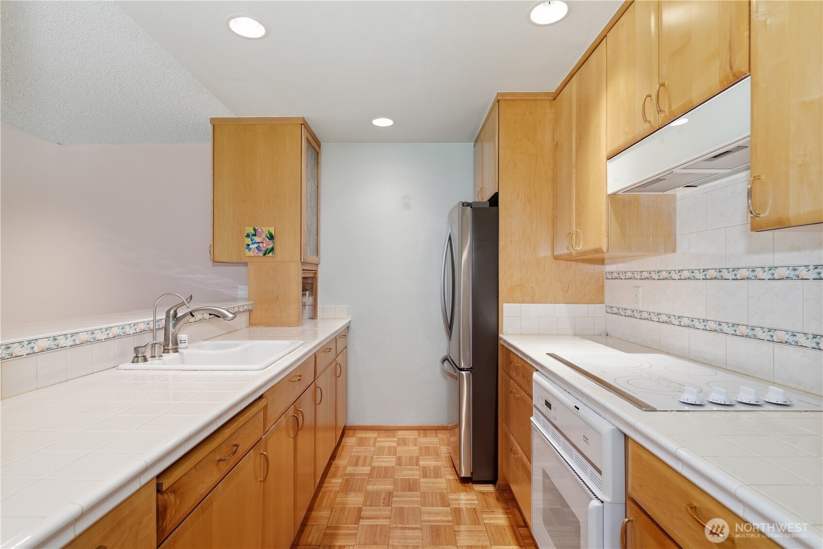 Maple cabinets, original parquet flooring and newer SS refrigerator