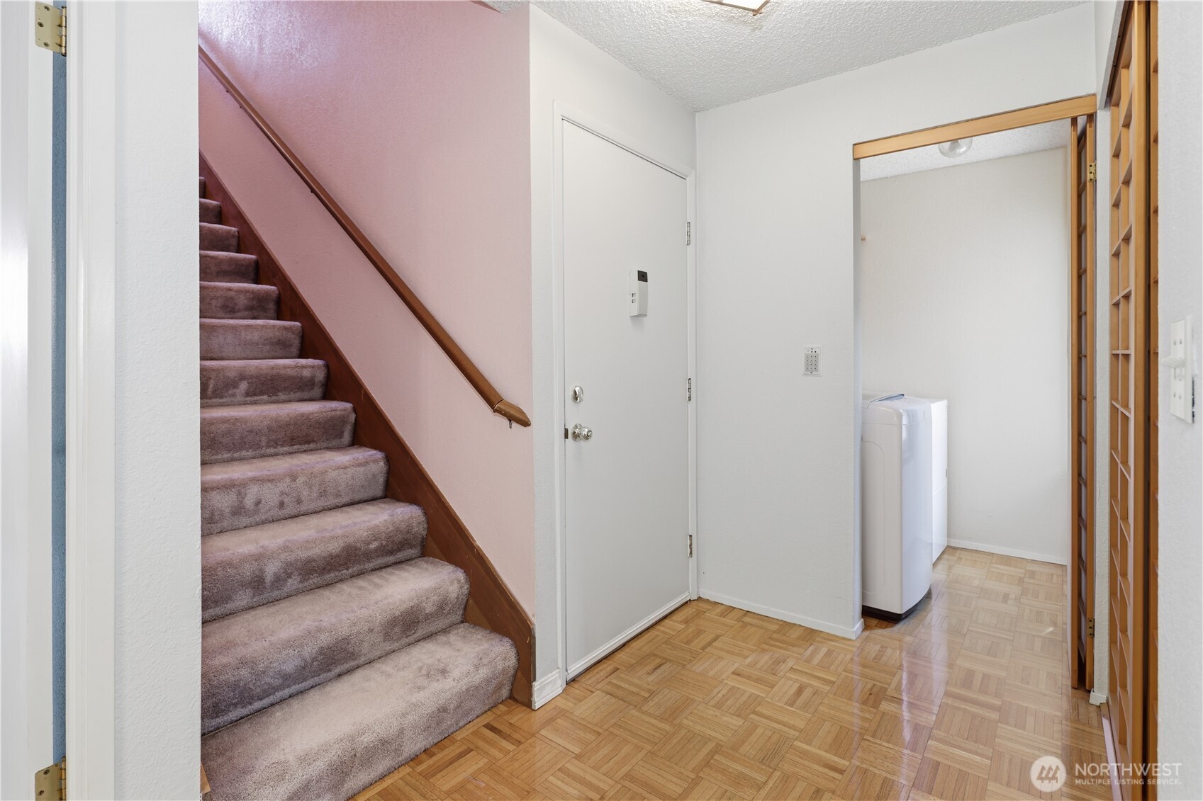 Laundry room with generous window to the left of the entry.