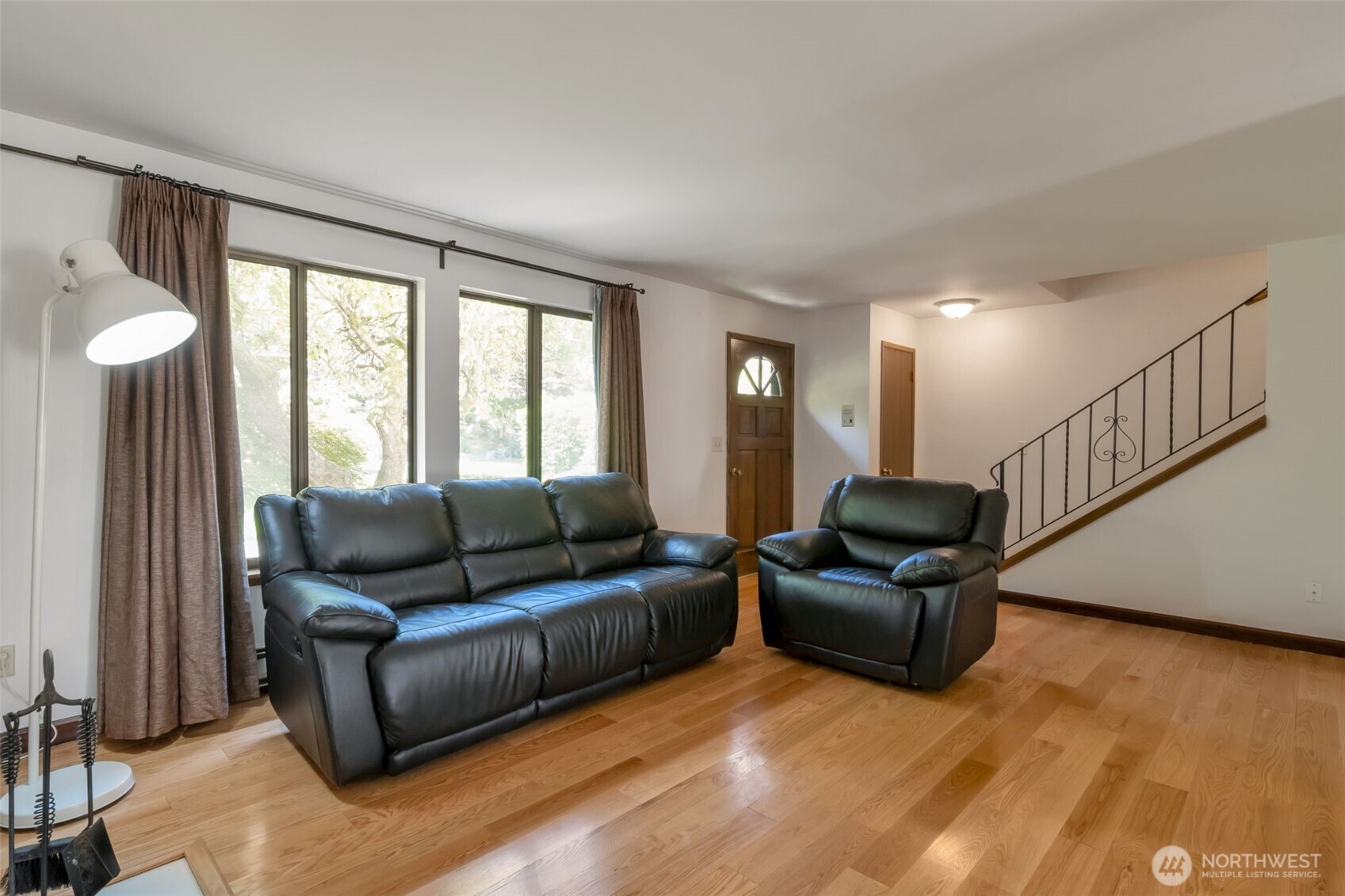 Open living and dining area with a cozy fireplace